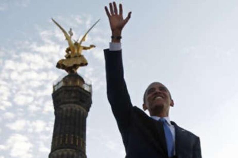 Barack Obama waves to the crowd as he arrives to deliver a speech at the Victory Column in Berlin yesterday.