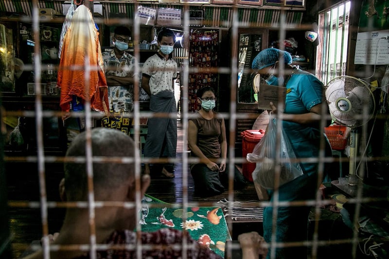 An election official is seen in a residence in Yangon last week, as advance voting in the country's elections began for elderly people. AFP