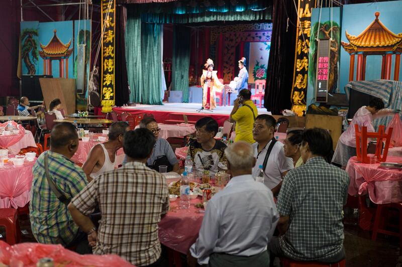 Guests enjoy a meal while watching the show. EPA