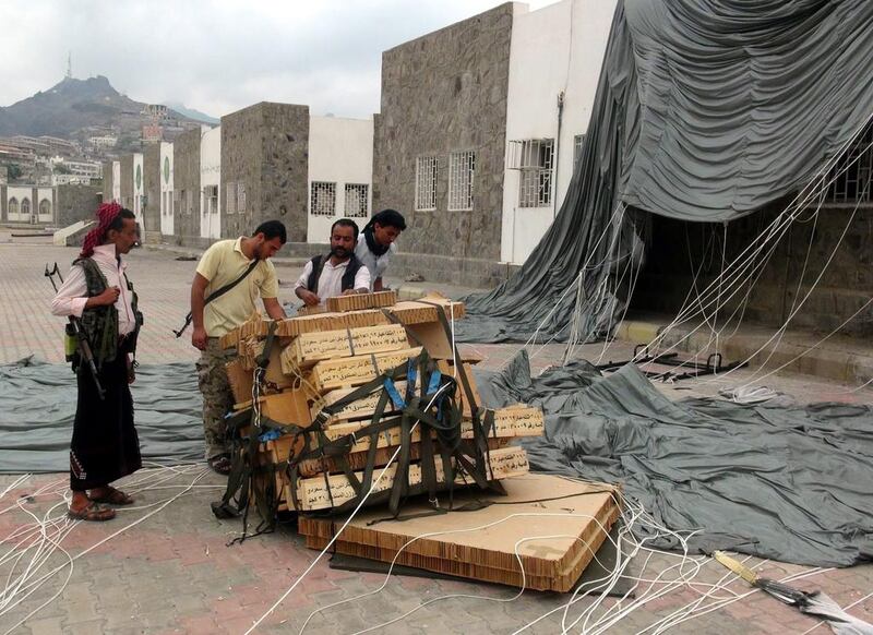 Militiamen loyal to Yemeni president Abdrabu Mansur Hadi collect boxes full of weapons dropped by the Saudi-led coalition in Aden on April 3, 2015. EPA