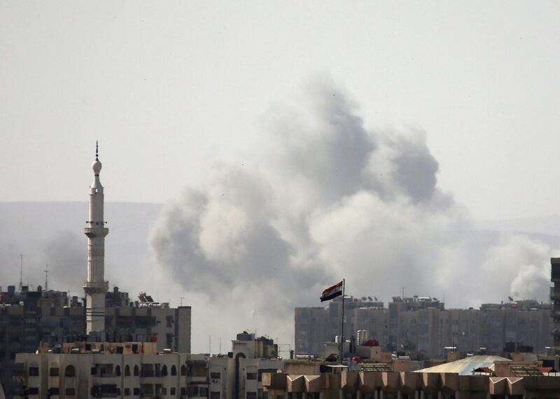 FILE PHOTO: Smoke rises from Yarmouk Palestinian camp in Damascus, Syria April 20, 2018. REUTERS/Ali Hashisho/File Photo