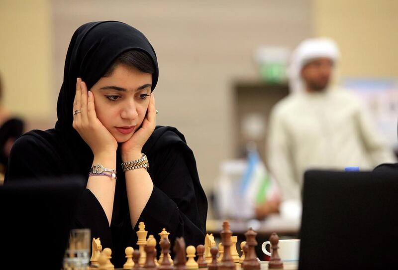 Emirati Kholoud Essa Al Zarouni ponders her next move at the Asian Nations Cup Chess Championship yesterday at the Novotel hotel in Abu Dhabi. The UAE is hosting the championship for a third consecutive year. Ravindranath K / The National