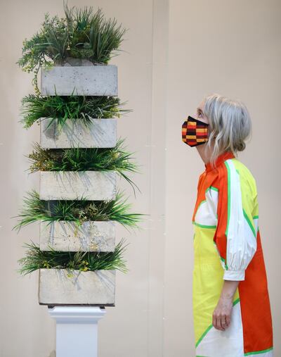 An assistant poses as she looks at "On Hunger and Farming in the Skies of the Past 1957-1966" by Ibrahim Mahama, one of six artworks shortlisted as the next design for the Fourth Plinth at Trafalgar Square, on display inside the National Gallery in London, Britain, May 24, 2021. REUTERS/Hannah McKay