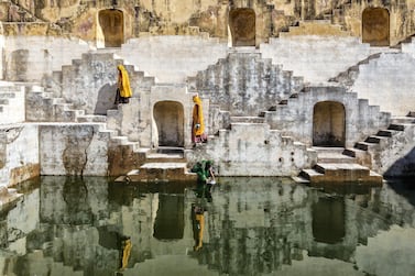 Women carry water at step well in Jaipur, one of the world's newest Unesco World Heritage Sites. Getty Images