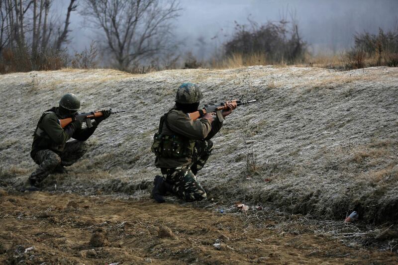 Indian paramilitary force soldiers take position at the site where suspected rebels stormed a paramilitary camp at southern Lethpora village in Indian controlled Kashmir, Sunday, Dec. 31, 2017. A number of Indian soldiers and suspected militants were killed Sunday after rebels stormed a paramilitary camp in disputed Kashmir, officials said. (AP Photo/Mukhtar Khan)