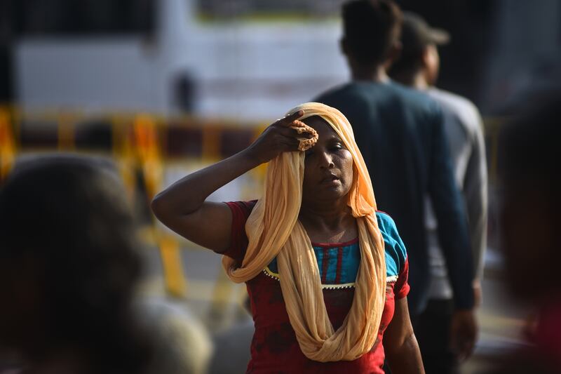 A woman covers her head with a cloth during a heatwave in Chennai, India, this month. EPA