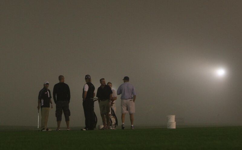 Dubai, UAE, Feb 10, 2011, Dubai Desert Classic Day 1- (center back to camera ) Miguel Angel Jimenez and other golfers on the fog covered range at the Dubai Desert Classic.  Mike Young / The National