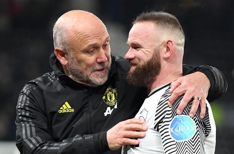 United coach Mike Phelan with Wayne Rooney. Getty