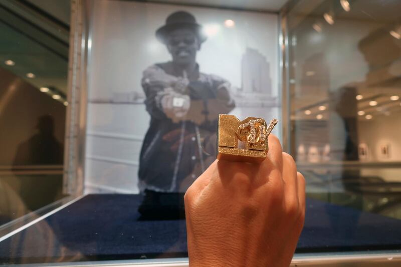 A woman holds Fab 5 Freddy's MTV ring at Sotheby's auction house in New York, Monday, Sept. 14, 2020. AP photo