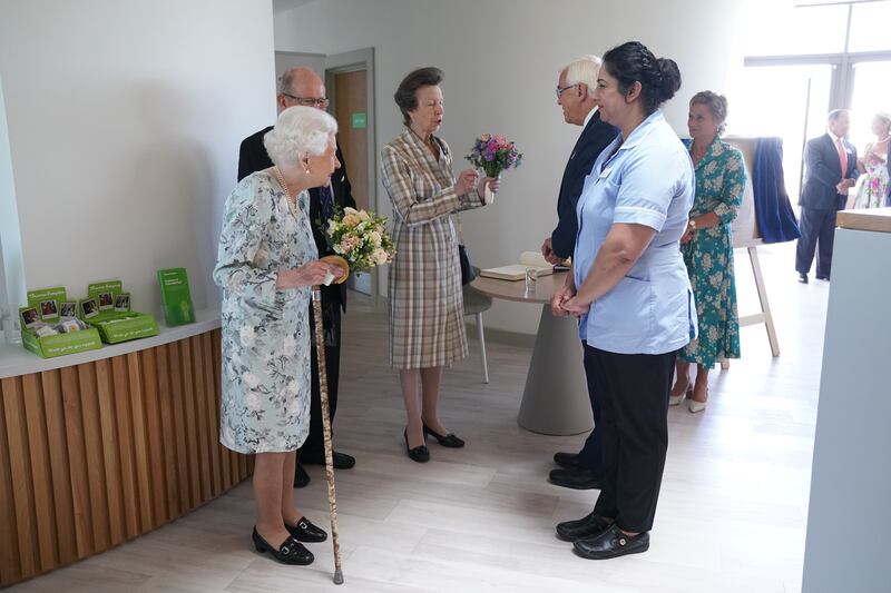 Queen Elizabeth and Princess Anne meet staff during a visit to officially open the new building at Thames Hospice in Maidenhead, in July 2022. 