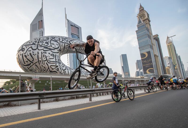 Riders on Sheikh Zayed Road during Dubai Ride, part of the Dubai Fitness Challenge, in 2022.  Ruel Pableo for The National