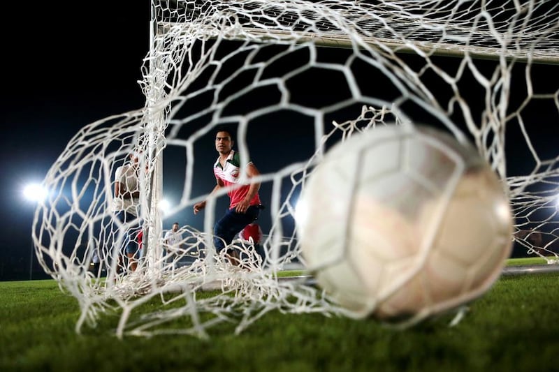 Workers play football on the outdoor lawn. Christopher Pike / The National