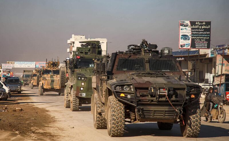 A Turkish military convoy of tanks and armoured vehicles passes through the Syrian town of Dana, east of the Turkish-Syrian border in the northwestern Syrian Idlib province.  AFP