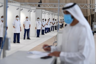 Nurses line up by cubicles in Dubai's World Trade Centre field hospital. Karim Sahib / AFP