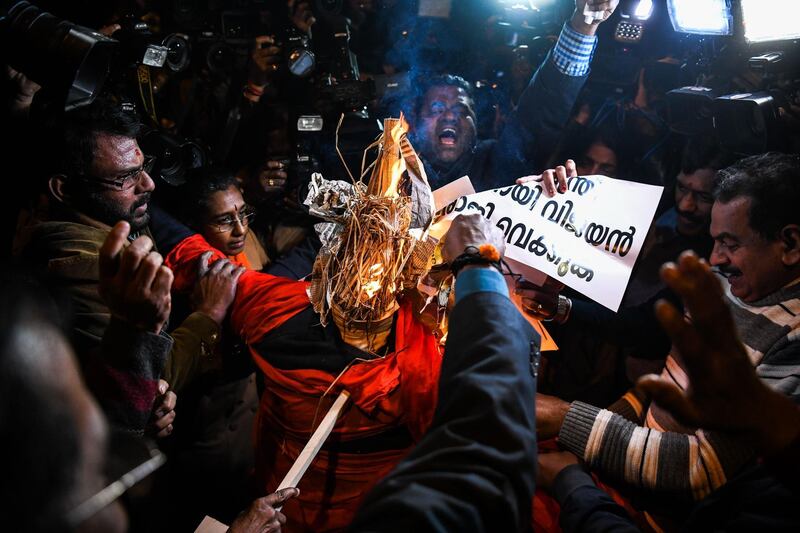 Indian Hindu activists burn effigy of Chief Minister of Kerala Pinarayi Vijayan during a demonstration over two women entering the Sabarimala Ayyapa temple in the southern state of Kerala, in New Delhi on January 3, 2019. Clashes broke out in southern India for a second day on January 3 as Hindu hardliners went on the rampage, seeking to enforce a general shutdown in protest at two women entering one of the country's holiest temples. A day after violence among rival groups and with police left one man dead and 15 people injured, authorities said that 266 protestors had been arrested across the state of Kerala.
 / AFP / CHANDAN KHANNA
