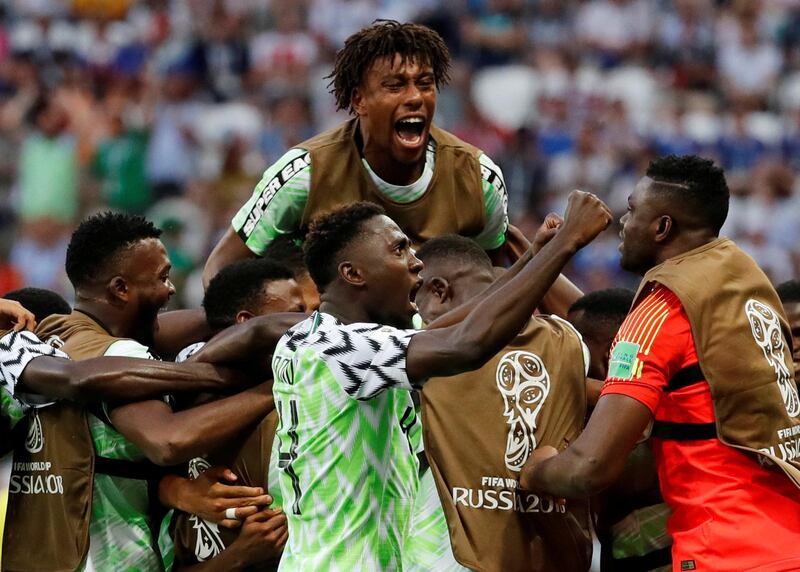 Nigeria players including Alex Iwobi, top, celebrate Ahmed Musa's first goal. Toru Hanai / Reuters