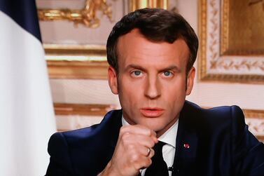 French President Emmanuel Macron is seen on a television screen as he speaks during a televised address to the nation on the outbreak of Covid-19, caused by the novel coronavirus, on March 16, 2020, in Paris. AFP 