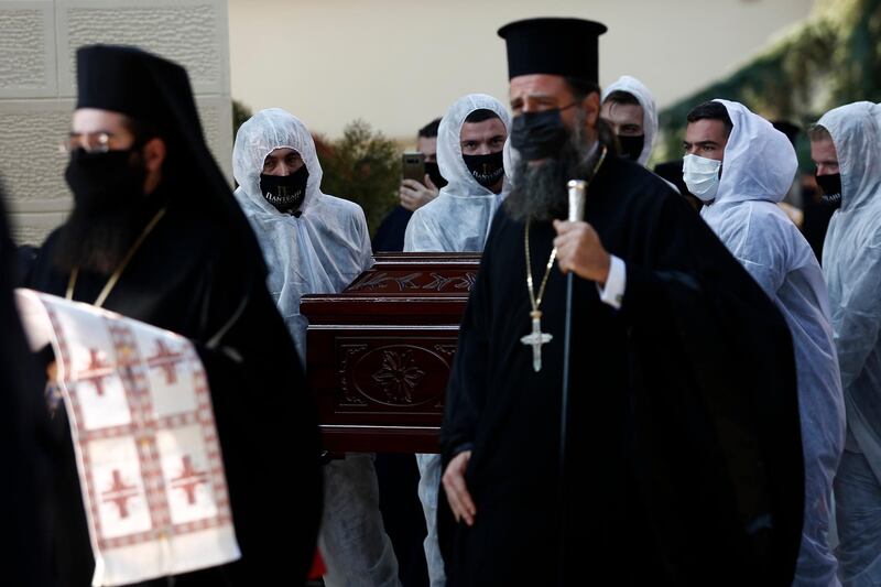 Priests wearing face masks to protect against the spread of the coronavirus, attend the funeral of senior clergyman Ioannis of Lagadas after he died of COVID-19,  in Greece's Orthodox Church, in the northern city of Thessaloniki, Greece. Metropolitan Bishop Ioannis of Lagadas, 62, was an outspoken advocate of maintaining communion ceremonies _ at which worshipers are given bread as well as wine with a shared spoon _ during the pandemic, arguing that there was no risk of transmission.  AP Photo