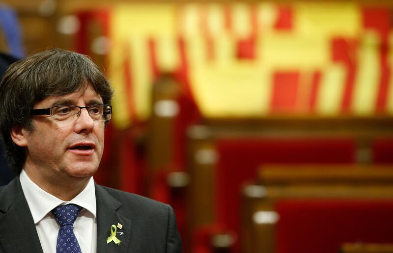 FILE - This is a Friday, Oct. 27, 2017 file photo of Catalan President Carles Puigdemont chants the Catalan anthem after a vote on independence in the Catalan parliament in Barcelona, Spain. The flight of Cataloniaâ€™s former leader Carles Puigdemont to Belgium is creating divisions within the Belgian government and risks damaging ties with EU partner Spain. As Carles Puigdemont was questioned by an investigating judge Sunday, Nov. 5, 2017  government ministers, Belgian politicians and Spanish officials were trading barbs on mainstream and social media.  (AP Photo/Manu Fernandez/File)