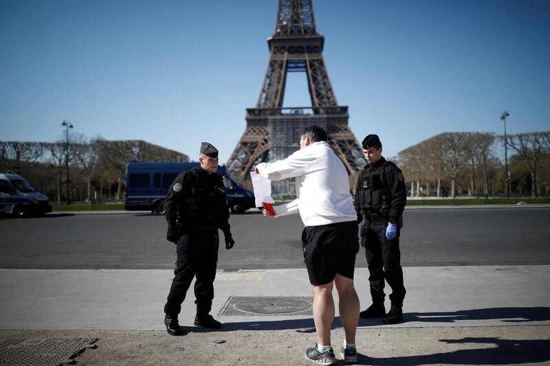 French Gendarmes control a man near the Eiffel tower in Paris. Reuters