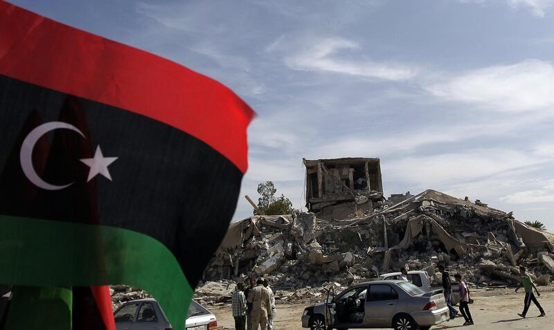 (FILES) In this file photo taken on November 1, 2011, Libyans arrive to inspect the remains of the destroyed "Beit al-Samed" or "The Resisting House", as dubbed by slain leader Moamer Kadhafi, in his Bab al-Aziziya compound after it was bombed by the US in 1986. Before Moamer Kadhafi's ouster Libyans avoided like the plague the Bab al-Aziziya compound from where the dictator ruled, but a housing shortage in Tripoli has forced squatters to move in. / AFP / JOSEPH EID
