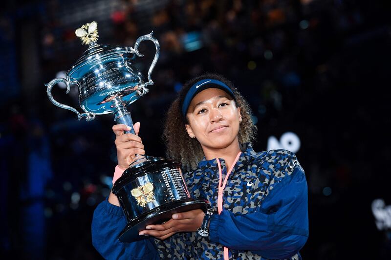 Naomi Osaka posing with the Daphne Akhurst Memorial Cup trophy after defeating Jennifer Brady of the US in their women's singles final match on day 13 of the Australian Open tennis tournament in Melbourne in 2021. AFP