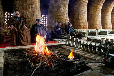 Members of an Iraqi clan gather inside a straw tent in the town of Mishkhab, south of Najaf on November 15, 2018. For centuries, Iraqi clans have used their own system to resolve disputes, with tribal dignitaries bringing together opposing sides to mediate in de facto "hearings" and if one side failed to attend the rival clan would fire on the absentee's home their fellow tribesmen's, a practice known as the "degga ashairiya" or "tribal warning". 
Authorities however are currently classifying it as a "terrorist act" punishable by death. / AFP / Haidar HAMDANI
