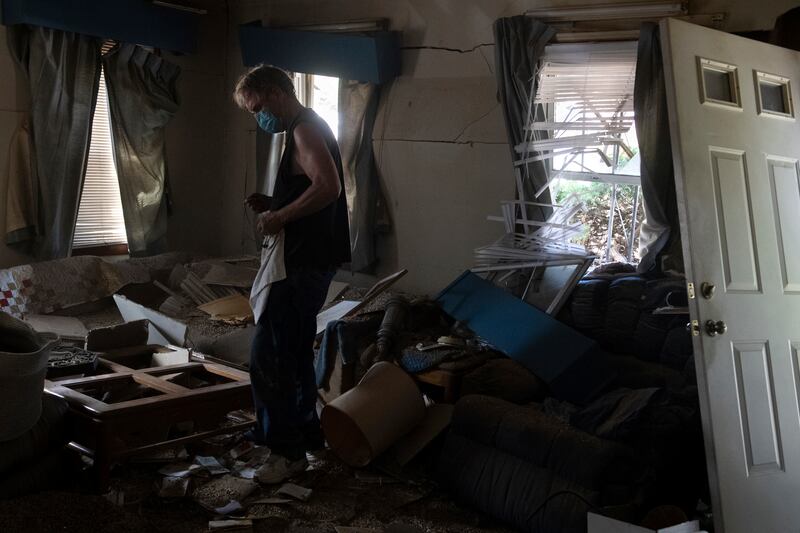 A man searches through the debris after the explosion. AP