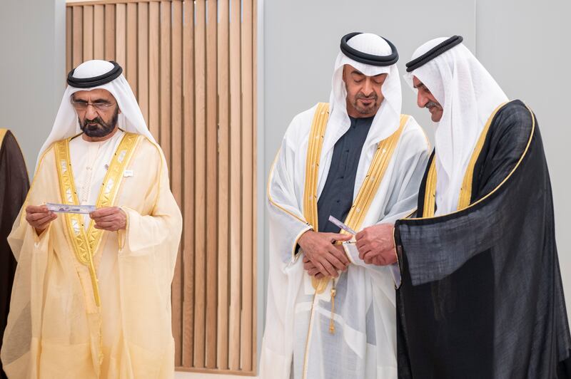 Sheikh Mohammed bin Rashid, Sheikh Mohamed bin Zayed and Sheikh Hamad bin Mohammed Al Sharqi attend the launch of new Dh50 banknote that has been issued by the UAE Central Bank to celebrate the country's 50th National Day, in December 2021. Photo: Presidential Court