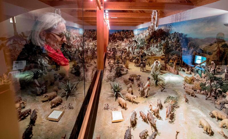 Visitors look at one of the world's largest nativity scene, accommodating 778 figures in a huge cabinet in the Austrian village of Christkindl. Joe Klamar / AFP Photo