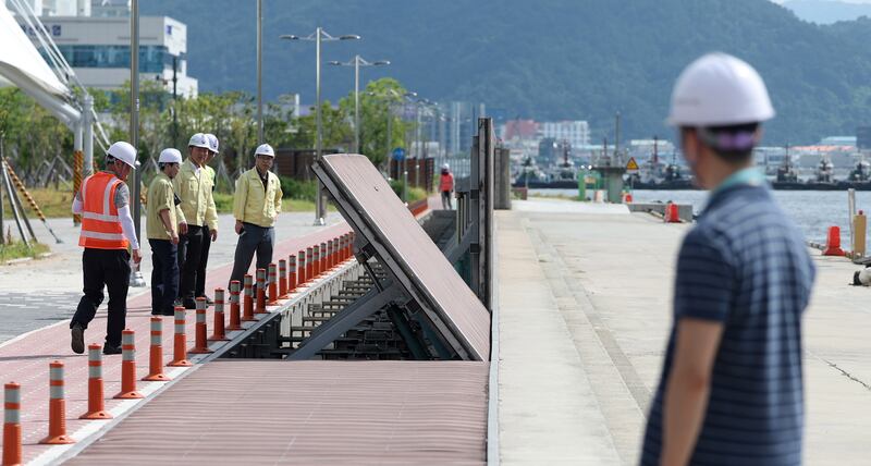 Engineers test wave barriers set up on the coast in Masan, South Korea, with Typhoon Khanun's arrival imminent. EPA