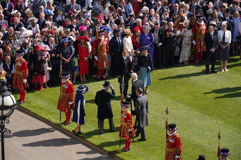 The royal couple step on to the lawn to meet guests at the garden party. AP