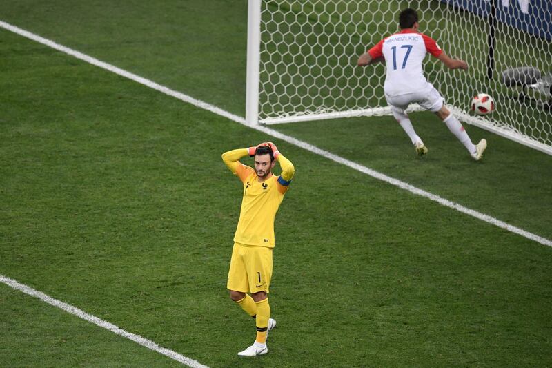 France's goalkeeper Hugo Lloris reacts after letting in a goal by Croatia's forward Mario Mandzukic (R) during the Russia 2018 World Cup final football match between France and Croatia at the Luzhniki Stadium in Moscow on July 15, 2018. (Photo by GABRIEL BOUYS / AFP) / RESTRICTED TO EDITORIAL USE - NO MOBILE PUSH ALERTS/DOWNLOADS