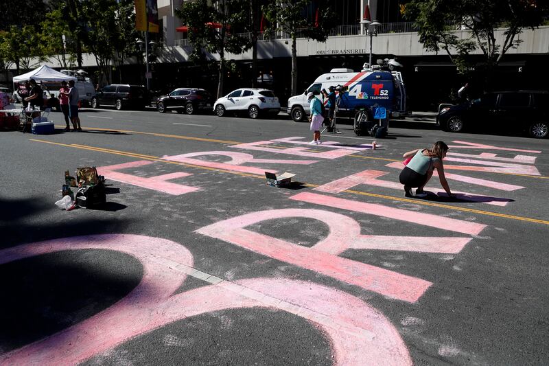 A demonstrator writes 'Free Britney' in chalk outside the Stanley Mosk Courthouse in Los Angeles. EPA