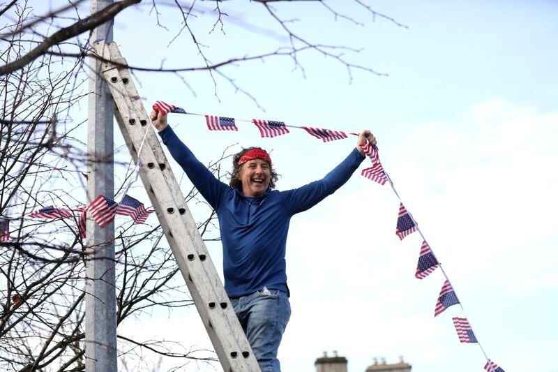 A man puts bunting up in the town of Ballina,  the ancestral home of Joe Biden in the north-west of Ireland, after he was elected  as the 46th president of the United States, defeating President Donald Trump. AP Photo