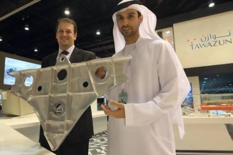 Majed Saif al Shamsi, sales and account manager, defence unit, and Vincent Mohni, senior manager-operations of Tawazun Precision Industries, TPI, with a display at Idex. Ravindranath K / The National