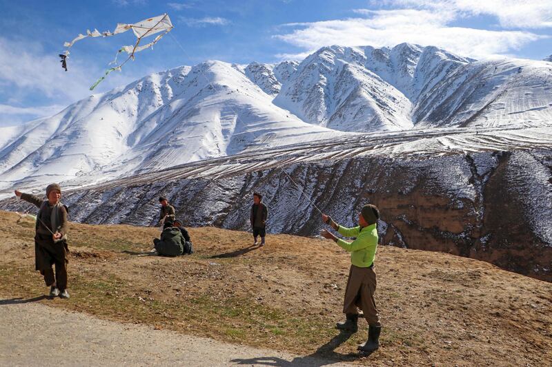 Afghan boys fly kites on a hilltop in Badakhshan. AFP
