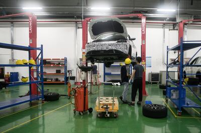 Workers inspect a prototype at the Xpeng Motors Technology Ltd. prototype center in Guangzhou, China, on Wednesday, June 6, 2018. Though Xpeng hasn't delivered a single vehicle, doesn't own a factory and hasn't obtained a production license from the government, the Chinese electric automaker expects to raise more than $600 million this month from investors that include Alibaba, valuing it close to $4 billion, according to a person familiar with the fundraising. Photographer: Giulia Marchi/Bloomberg