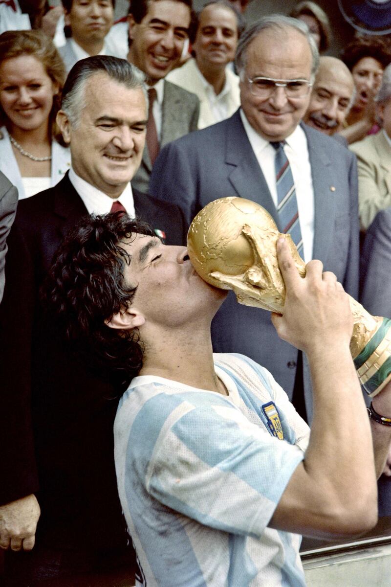 In this file picture taken on June 29, 1986 Argentina's captain Diego Maradona kisses the World Cup after a 3-2 victory over West Germany at the Azteca stadium in Mexico City. Maradona is self-isolating after one of his bodyguards displayed symptoms of Covid-19. AFP