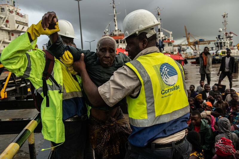 People from the town of Buzi are helped off a boat at Beira Port after being rescued in Beira, Mozambique. Getty Images