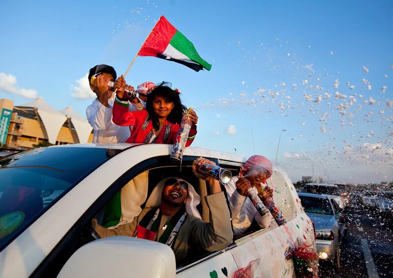 People join in celebration and show off their decorated cars during the Spirit of Union Parade on Thursday evening, Dec. 1, 2011, at the Yas Island near Abu Dhabi. (Silvia Razgova/The National)

