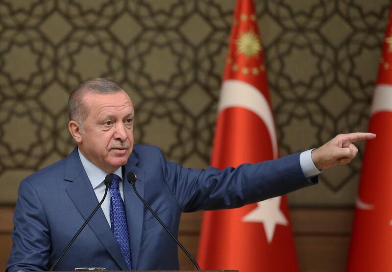 Turkish President Recep Tayyip Erdogan speaks during a meeting at his presidential palace, in Ankara, Turkey, Thursday, Oct. 24, 2019. Erdogan on Thursday renewed a threat to resume its military offensive if his country continued to be "harassed" by the Kurdish militia.( Presidential Press Service via AP, Pool )