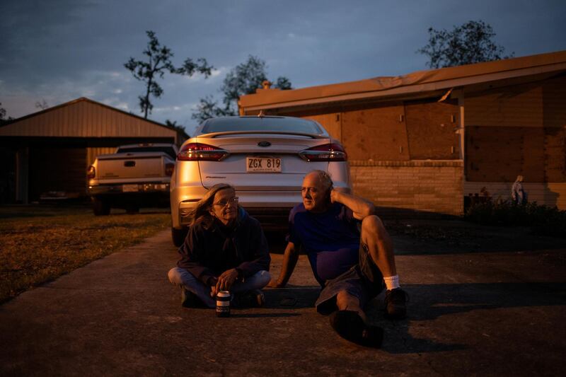 Ronda Fontenot, 58, and her partner Jesse Wamboldt, 54, sit in the driveway of their home damaged by Hurricane Laura as they await the arrival of Hurricane Delta in Lake Charles, Louisiana. Reuters