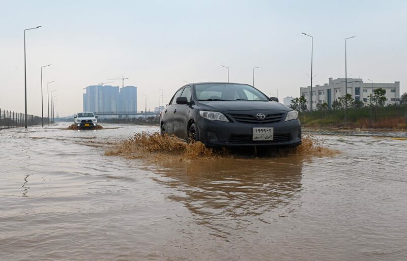 A car drives through floodwater in Erbil, the capital of Iraq's northern Kurdish autonomous region, following heavy rain on January 13.  All photos: Safin Hamed / AFP