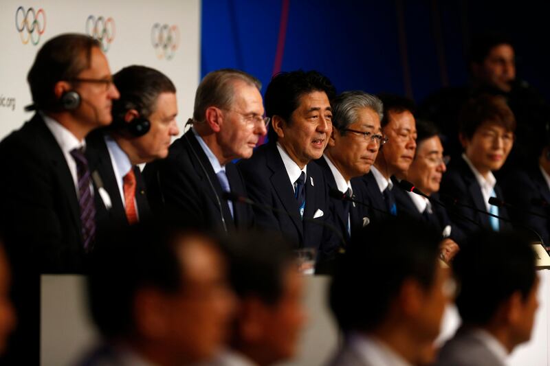 Japan's Prime Minister Shinzo Abe, fourth from left, and President of the International Olympic Committee Jacques Rogge, third from left, pose with members of the Japan's delegation after signing the Host City Contract for the 2020 Olympic Games in Buenos Aires, Argentina, Saturday, Sept. 7, 2013. Fifth from left is Tokyo 2020 Olympic Bid Committee President Tsunekazu Takeda, sixth from left is Tokyo's Governor Naoki Inose. Tokyo defeated Istanbul in the final round of secret voting Saturday by the International Olympic Committee. Madrid was eliminated earlier after an initial tie with Istanbul. (AP Photo/Victor Caivano) *** Local Caption ***  Argentina 2020 Vote Olympics.JPEG-055a5.jpg