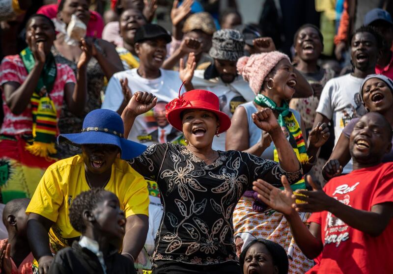 Members of the public sing as they gather in the stands for the funeral service of former president Robert Mugabe at the National Sports Stadium in the capital Harare, Zimbabwe. African heads of state and envoys are gathering to attend a state funeral for Mugabe, whose burial has been delayed for at least a month until a special mausoleum can be built for his remains. AP Photo
