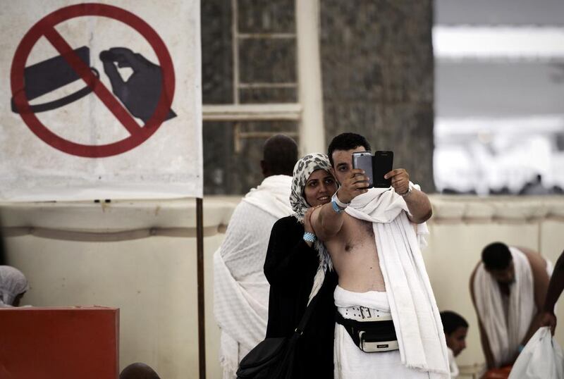 Pilgrims pose for a selfie during the "Jamarat" ritual in Mina in 2014. Mohammed Al Shaikh / AFP