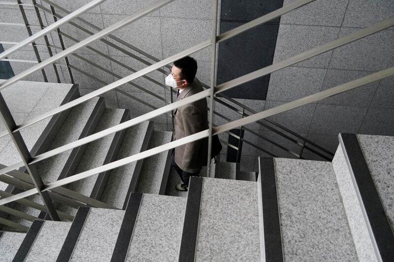 Park Hyun, a professor of Pusan National University Park Hyun who used to be a coronavirus patient, walks up the stairs at Pusan National University in Busan. Reuters