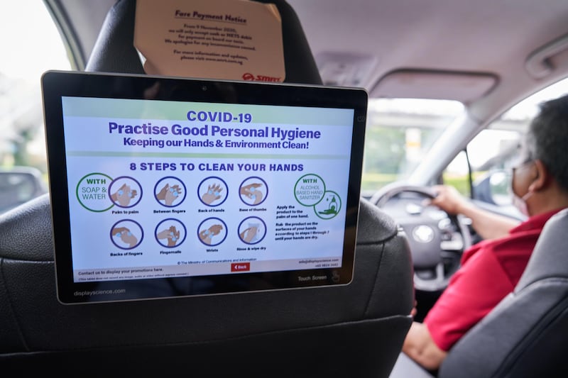 Instructions for practicing good personal hygiene in a taxi in Singapore, on Friday, Jan. 15, 2021. Singapore is speeding a new law through parliament to allow the use of contact tracing data for criminal investigations after recent disclosures spurred concern that the government was using the information for more than just fighting Covid-19. Photographer: Lauryn Ishal/Bloomberg