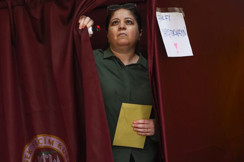 A woman casts her ballot at a polling station in Ankara. EPA